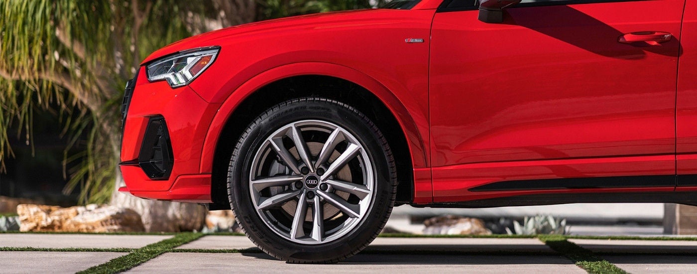 Front driver side wheel on a red 2024 Audi Q3.